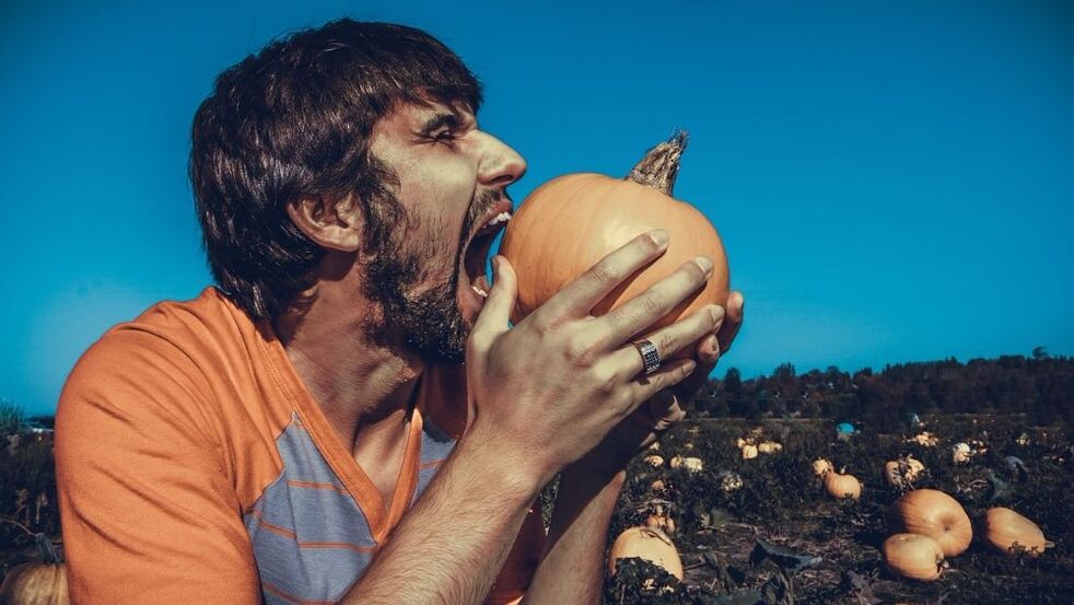 A man eats pumpkin to increase strength